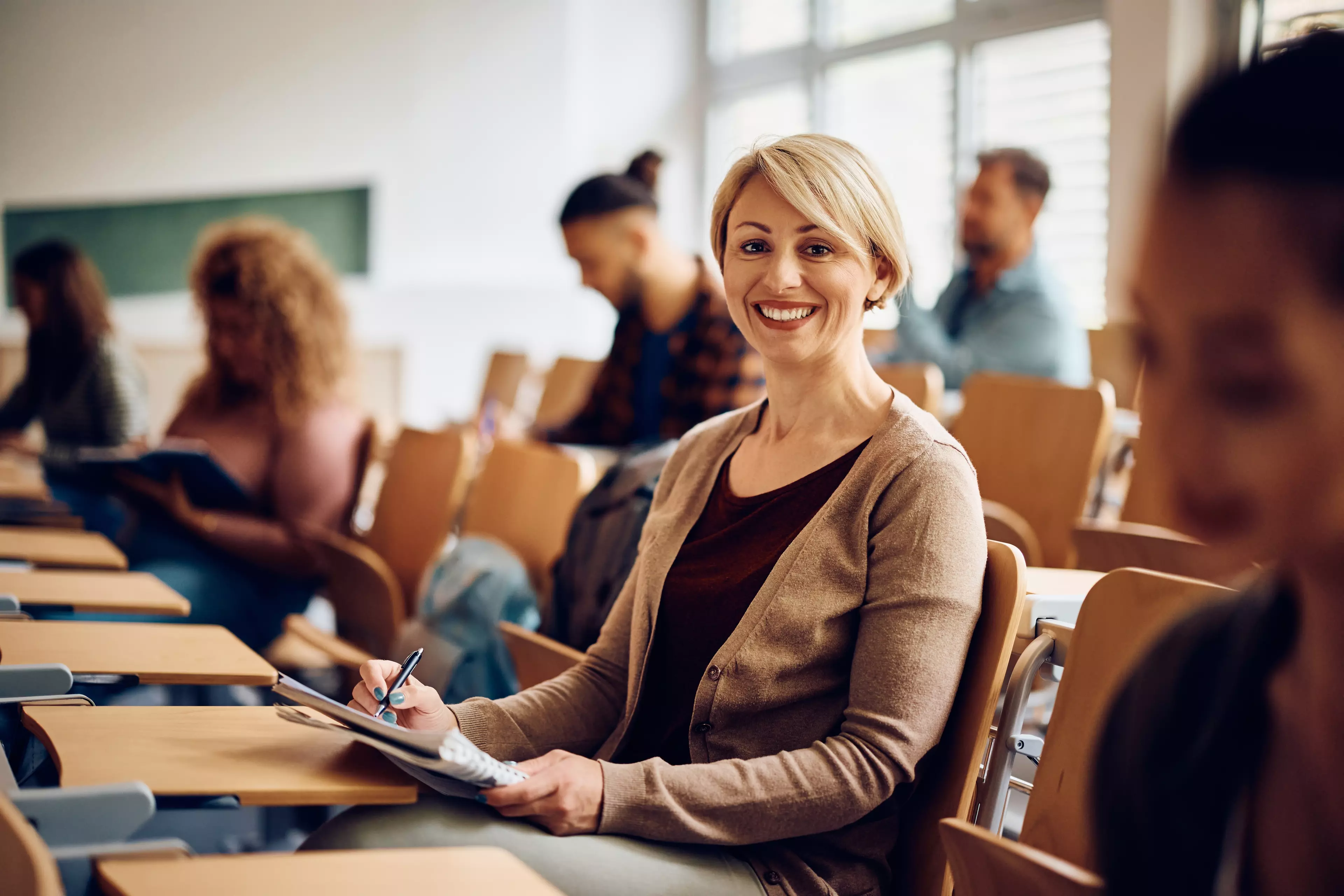 Young, smiling, blonde woman sitting an on-site test